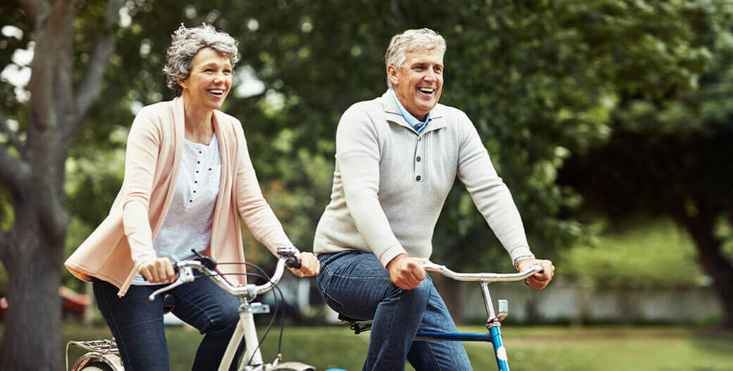 couple riding a bike outside with dentures in Columbia, South Carolina